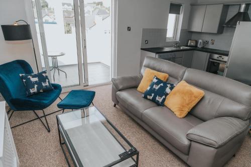a living room with a couch and a table at Causeway Coast Sea Shore Apartment - Ballycastle in Ballycastle