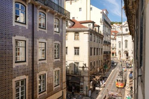 a view of a city street with a tram at Historic Center romantic apartment in Lisbon