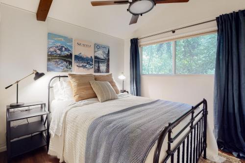 a bedroom with a large bed and a window at Calamity Cabin in Gig Harbor