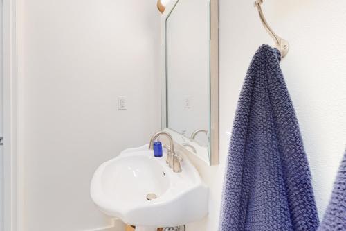 a bathroom with a sink and a blue towel at Calamity Cabin in Gig Harbor