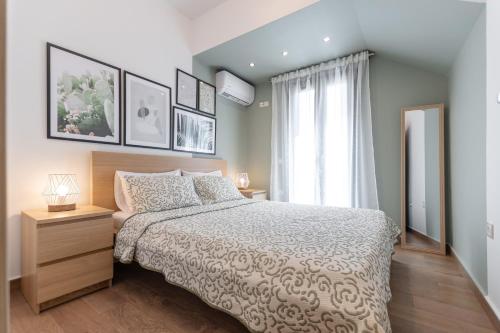 a bedroom with a large bed and a window at Naxos Alma House in Naxos Chora