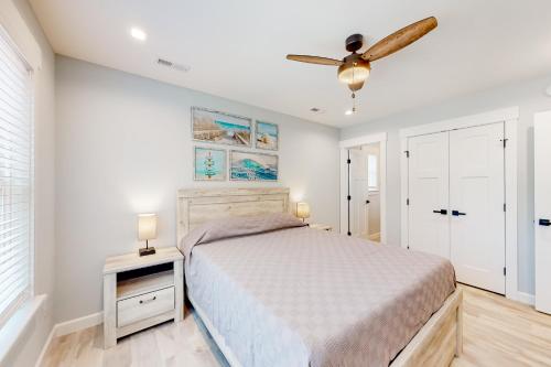 a bedroom with a bed and a ceiling fan at Coastal Paradise in Avon