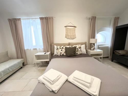 a bedroom with a large bed with towels on it at L Antico Forno Bari Centro Storico in Bari