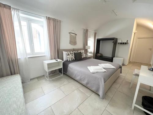 a bedroom with a bed and a window at L Antico Forno Bari Centro Storico in Bari