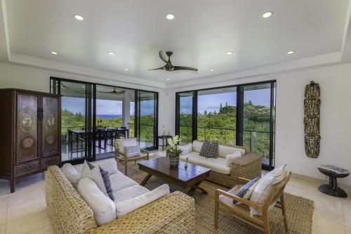 a living room with couches and a table at Luxury Zen Retreat home in Princeville