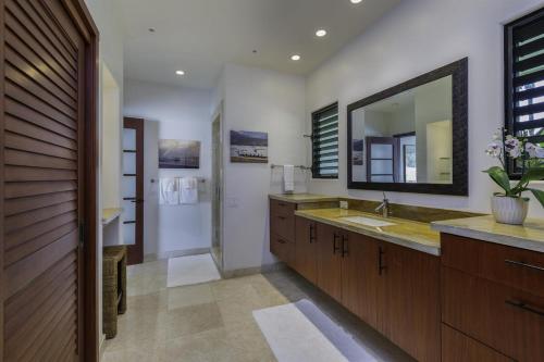 a bathroom with a sink and a mirror at Luxury Zen Retreat home in Princeville