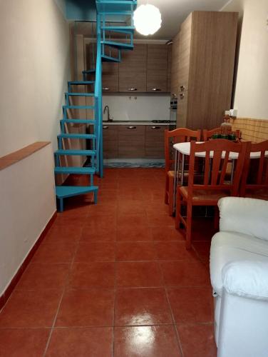 a living room with a staircase and a table and chairs at Casa vacanze da CLARA in Castrovillari