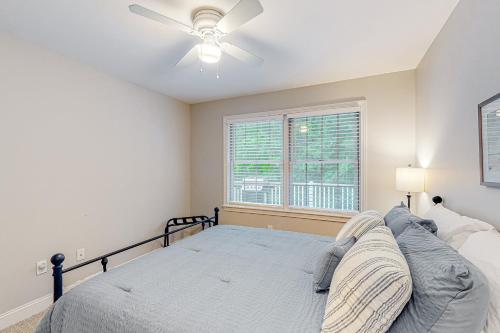 a bedroom with a bed and a ceiling fan at Panther Run River Retreat in Raymond