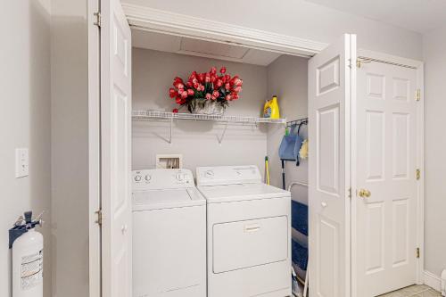 a white laundry room with a washer and dryer at Panther Run River Retreat in Raymond