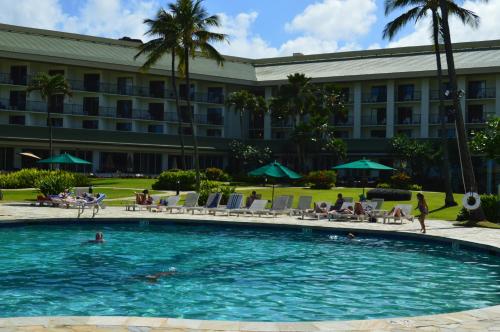 a swimming pool in front of a hotel at 2417 at Oceanfront Resort Lihue Kauai Beach Drive Private Condo in Lihue
