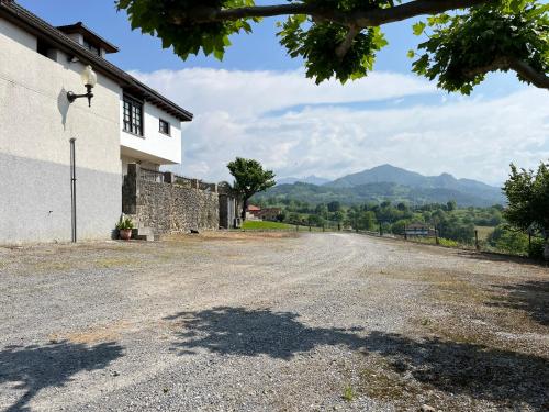 an empty road in front of a building at Los Cuetos in Santianes