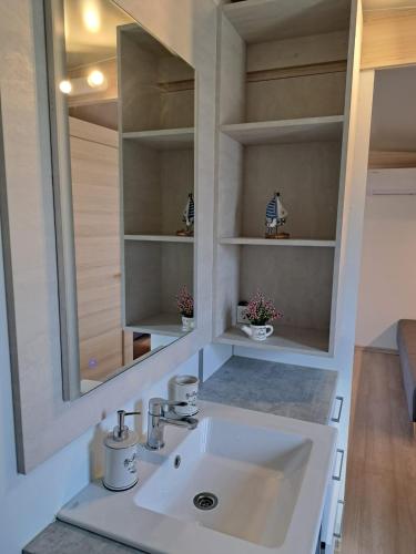a bathroom with a sink and a mirror at Mobile Home Drage in Drage