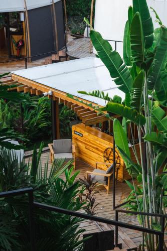 a wooden bench sitting on top of a wooden deck at Art Villas Costa Rica, Villas & Glamping in Uvita