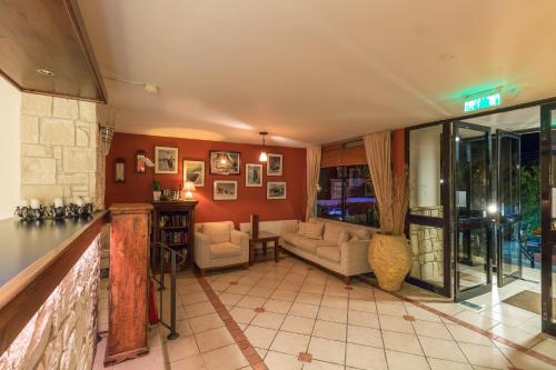 a living room with red walls and a fireplace at Hill View Hotel Apartments in Pissouri