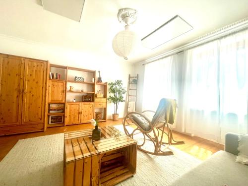 a living room with a chair and a coffee table at Landhaus mit Garten in Neutal