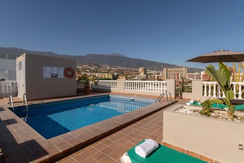 a swimming pool on the roof of a building at Hotel Marte in Puerto de la Cruz