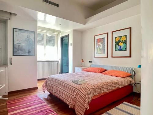 a bedroom with a large bed with orange pillows at Wonderful Roma in Rome