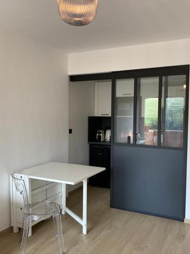 - une cuisine avec une table et des chaises blanches dans la chambre dans l'établissement Elsa & David, à Collioure