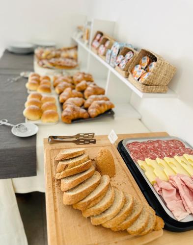 a buffet of pastries and breads on a table at InVilla Bed&Breakfast - Quality Rooms in Santa Maria di Castellabate