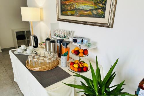 a table with food and drinks and fruit on it at InVilla Bed&Breakfast - Quality Rooms in Santa Maria di Castellabate