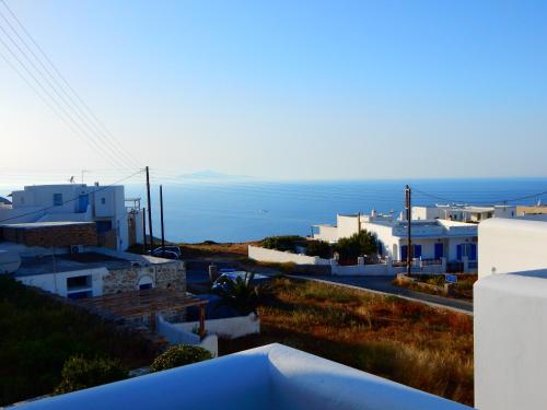a view of a city with the ocean in the background at Aegeo Hotel in Chora Folegandros