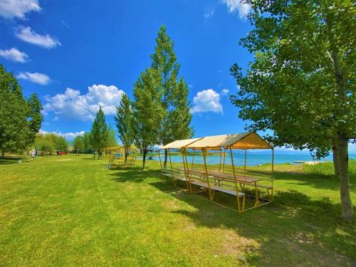 a row of tents in a park near the water at Geghama Garden House - Resort Sevan in Sevan