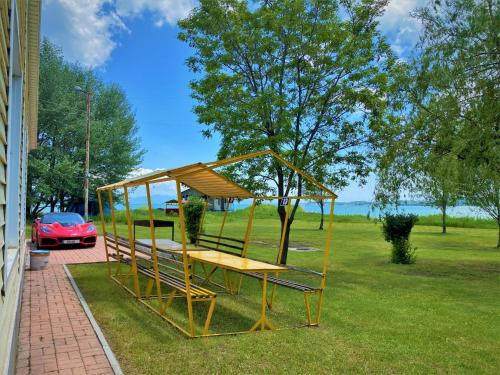 a playground with a picnic table in the grass at Geghama Garden House - Resort Sevan in Sevan