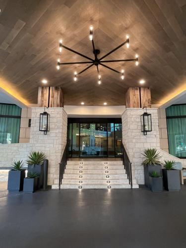 a lobby of a building with a large clock on the ceiling at Hotel Contessa - Suites on the Riverwalk in San Antonio