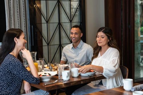 a group of three people sitting at a table at Hotel Contessa - Suites on the Riverwalk in San Antonio
