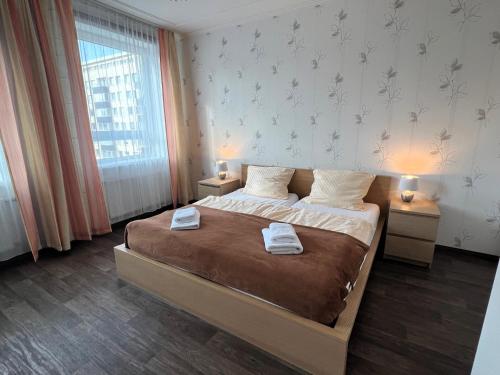 a bedroom with a large bed with two night stands at Ferienwohnungen an der Weser in Bremerhaven