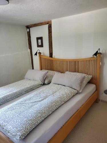 a bed with two pillows on it in a room at Donauwelle in Sigmaringendorf