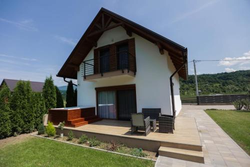 a house with a balcony and a lawn at Villa Sara on river Una in Bihać