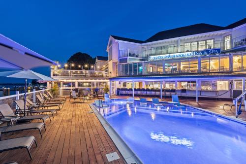a hotel with a swimming pool in front of a building at St Michaels Harbour Inn, Marina and Spa in Saint Michaels