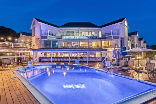 a large building with a swimming pool in front of it at St Michaels Harbour Inn, Marina and Spa in Saint Michaels