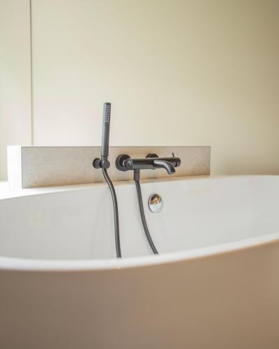 a bathtub with a faucet in a bathroom at Domaine de La Soudelle in Chanceaux-sur-Choisille