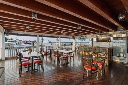 a restaurant with tables and chairs on a deck at St Michaels Harbour Inn, Marina and Spa in Saint Michaels
