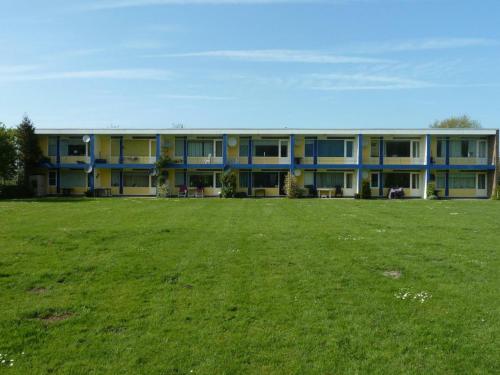 an empty field in front of a large building at Vakantiehuisje Martina 11 in Vlissingen