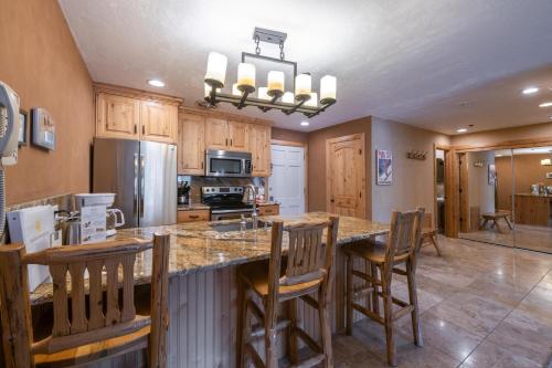 a kitchen with a large island with wooden cabinets at Treasure Mountain Inn in Park City
