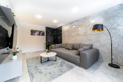 a living room with a couch and a table at Apartmán Discreet in Kysucké Nové Mesto