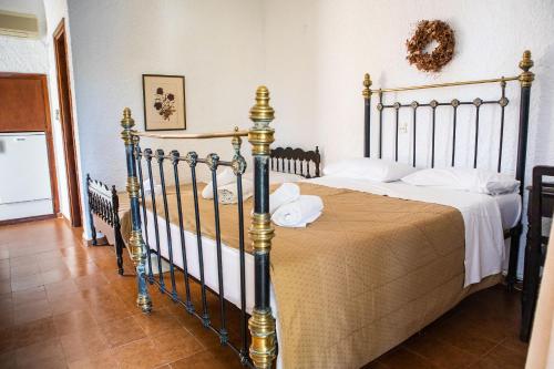 a bedroom with a large bed with a bedspread at Vagia Traditional, Aegina Island in Vaia