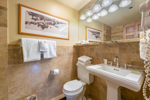 a bathroom with a toilet and a sink at Treasure Mountain Inn in Park City