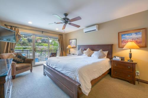 a bedroom with a bed and a couch and a window at Treasure Mountain Inn in Park City