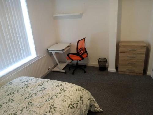 um quarto com uma cama, uma secretária e uma cadeira em Double-bed H4 close to Burnley city centre em Burnley