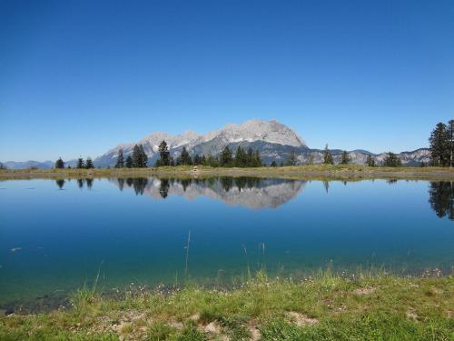 a view of a lake with mountains in the background at Apartment Kitzkamm by Apartment Managers in Kitzbühel