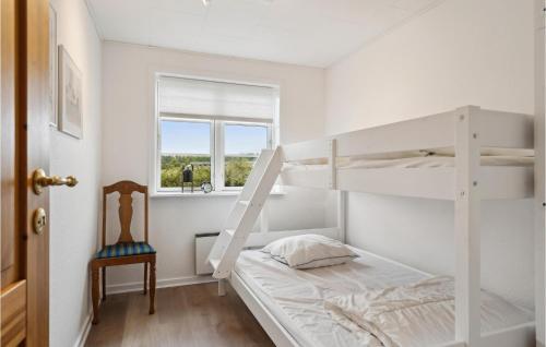 a bedroom with two bunk beds and a chair at Lovely Home In Hesselager With Wifi in Hesselager