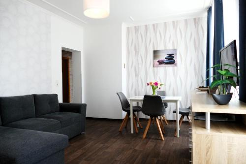a living room with a couch and a table at Ferienwohnungen an der Weser in Bremerhaven