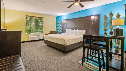 a hotel room with a bed and a desk at Magnuson Hotel Wildwood Inn Crawfordville in Crawfordville