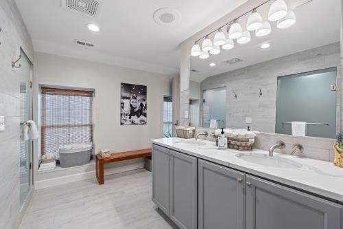 a bathroom with two sinks and a large mirror at St Michaels Harbour Inn, Marina and Spa in Saint Michaels