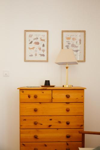 a wooden dresser with a lamp on top of it at La Borgnardais gîte en Brocéliande, proche Guer - 1 à 11 couchages in Loutehel