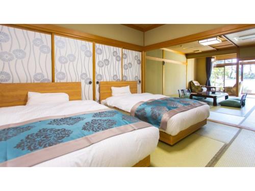 Säng eller sängar i ett rum på Tsukioka Onsen Furinya - Vacation STAY 55972v